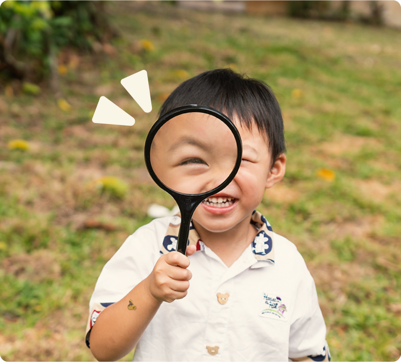 Child with magnifying glass